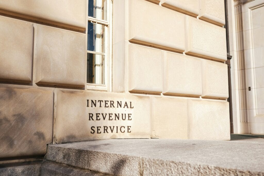 Internal Revenue Service building exterior with engraved stone signage, the US agency whose 2026 tax brackets and OBBBA changes are discussed in this article