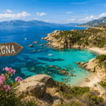 Sardegna wooden directional sign overlooking a turquoise cove with rocky coastline, sandy beach, and mountains in the background