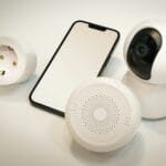 Smart home devices including a smartphone, smart plug, indoor security camera, and a motion or smoke sensor arranged together