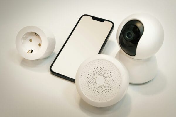 Smart home devices including a smartphone, smart plug, indoor security camera, and a motion or smoke sensor arranged together