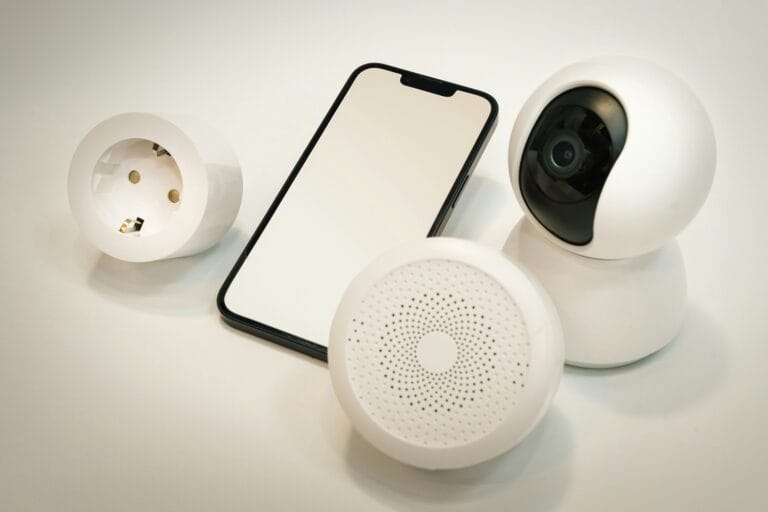 Smart home devices including a smartphone, smart plug, indoor security camera, and a motion or smoke sensor arranged together